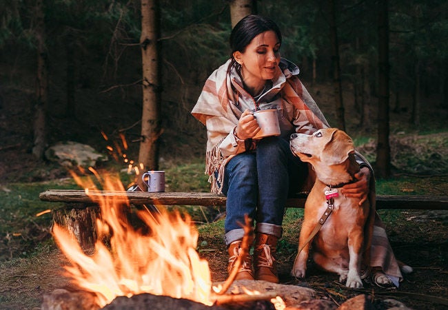 Woman camping with dog