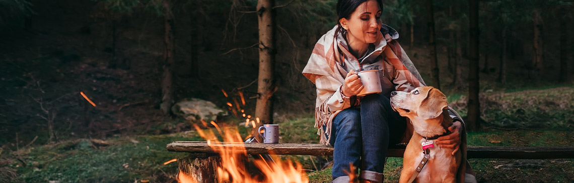 Woman camping with dog