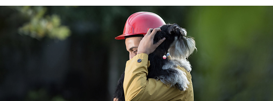 Rescue worker carrying a dog
