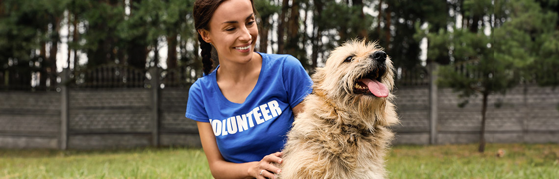 Volunteer hanging out with dog